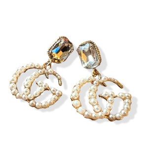 Gold toned pearl dangle monogram earrings